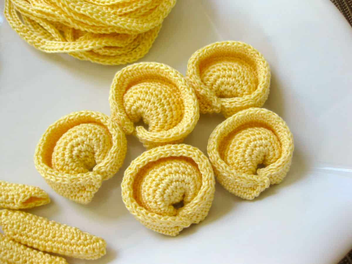 Compelling Resemblance of Crochet Piles of Yellow Pasta to Their Edible Counterparts
